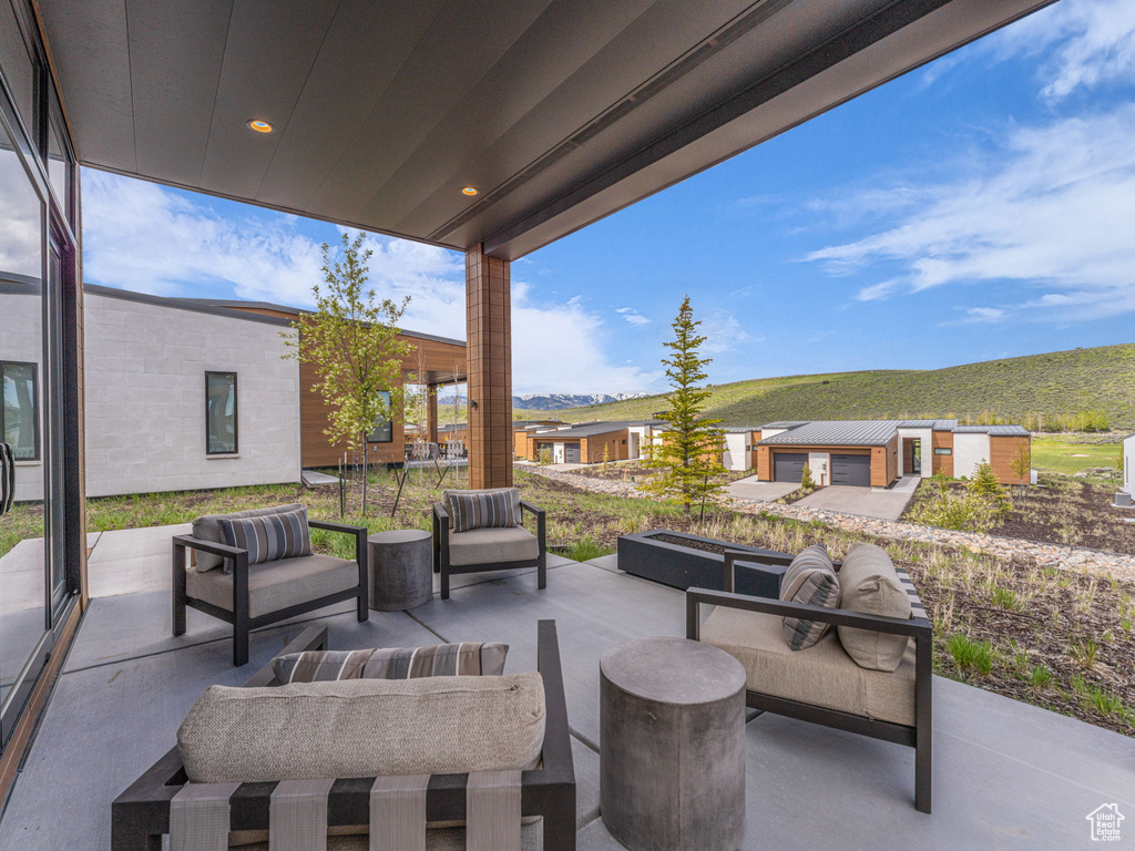 View of patio with outdoor lounge area and a mountain view
