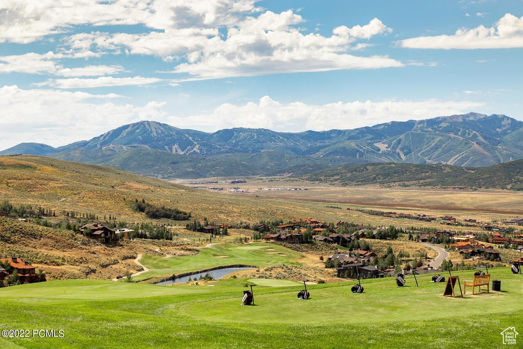 View of mountain background with a golf course and a nearby body of water