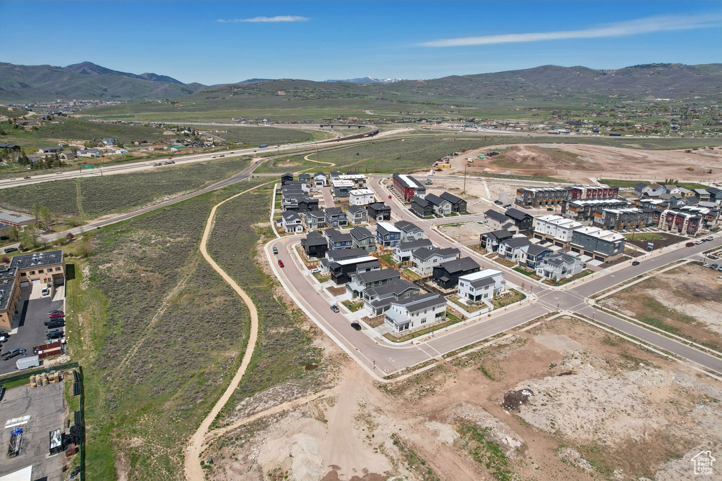 Aerial overview of property's location featuring a mountain backdrop
