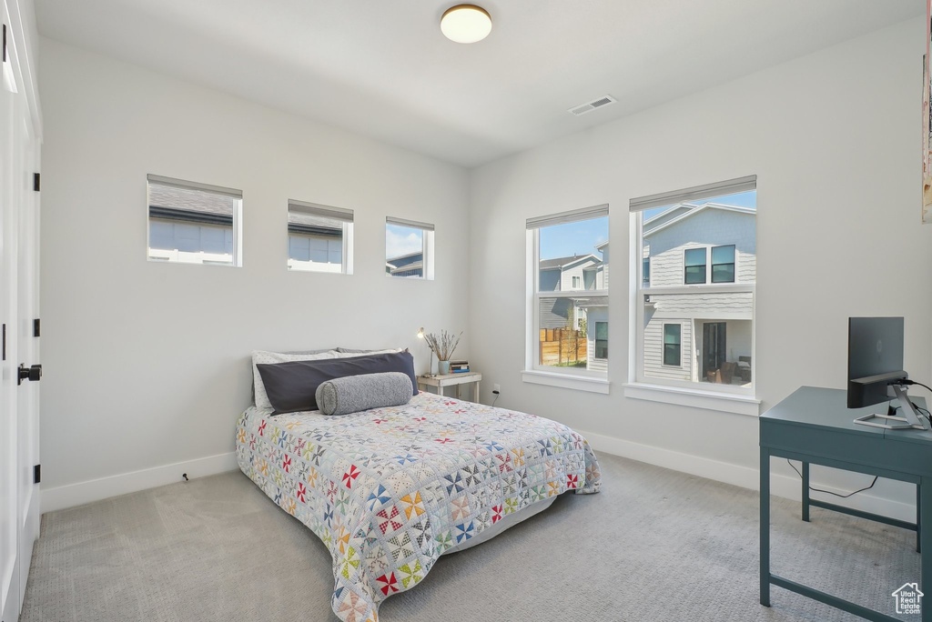 Bedroom with carpet floors, baseboards, and an office area