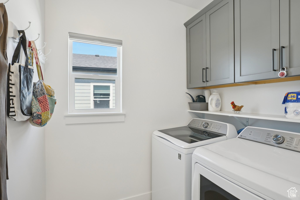 Laundry area featuring washer and dryer and cabinet space