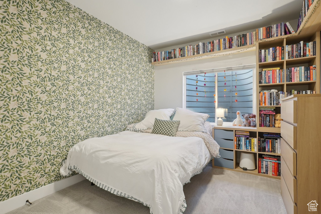 Carpeted bedroom featuring wallpapered walls and baseboards