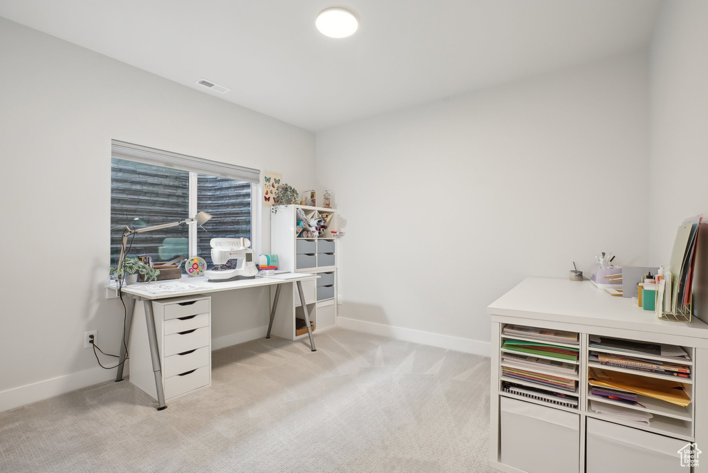 Office area with light carpet and baseboards