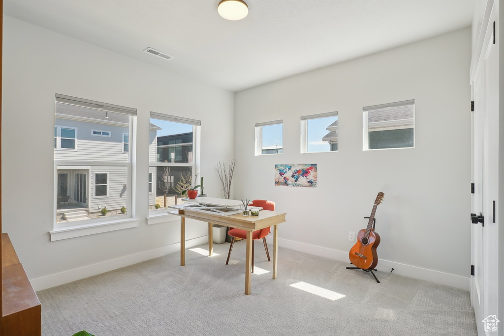 Office area with baseboards and carpet