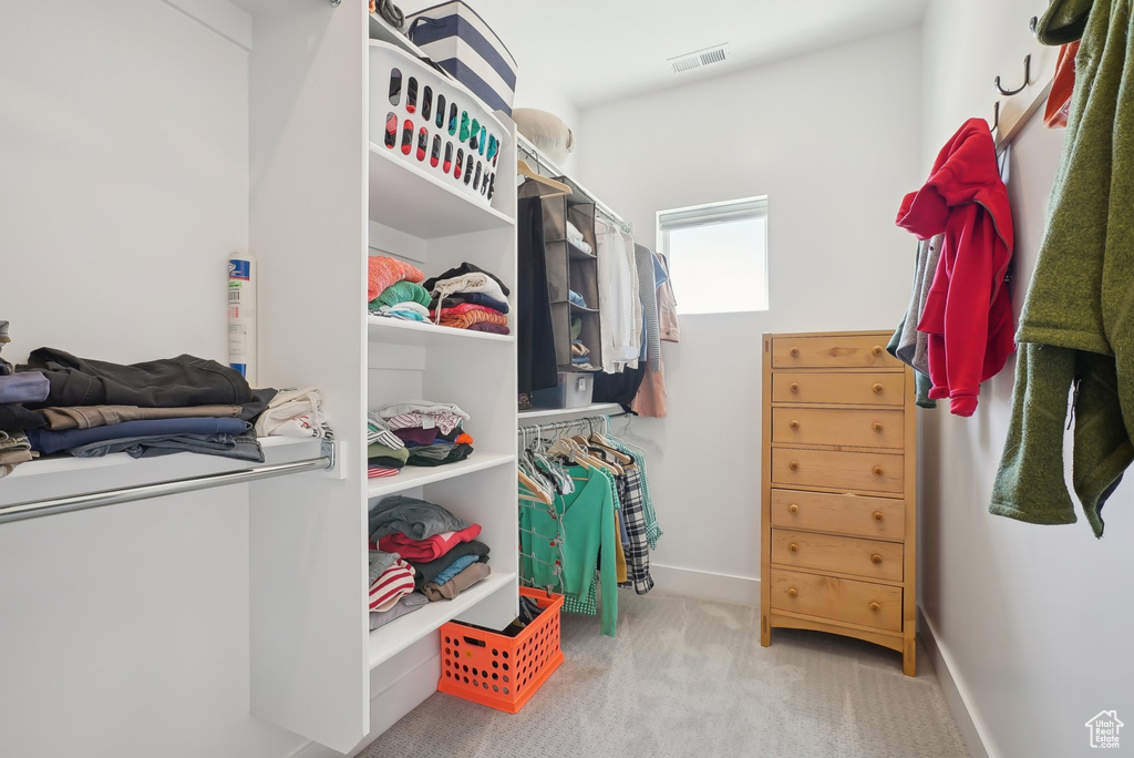 Spacious closet with carpet floors