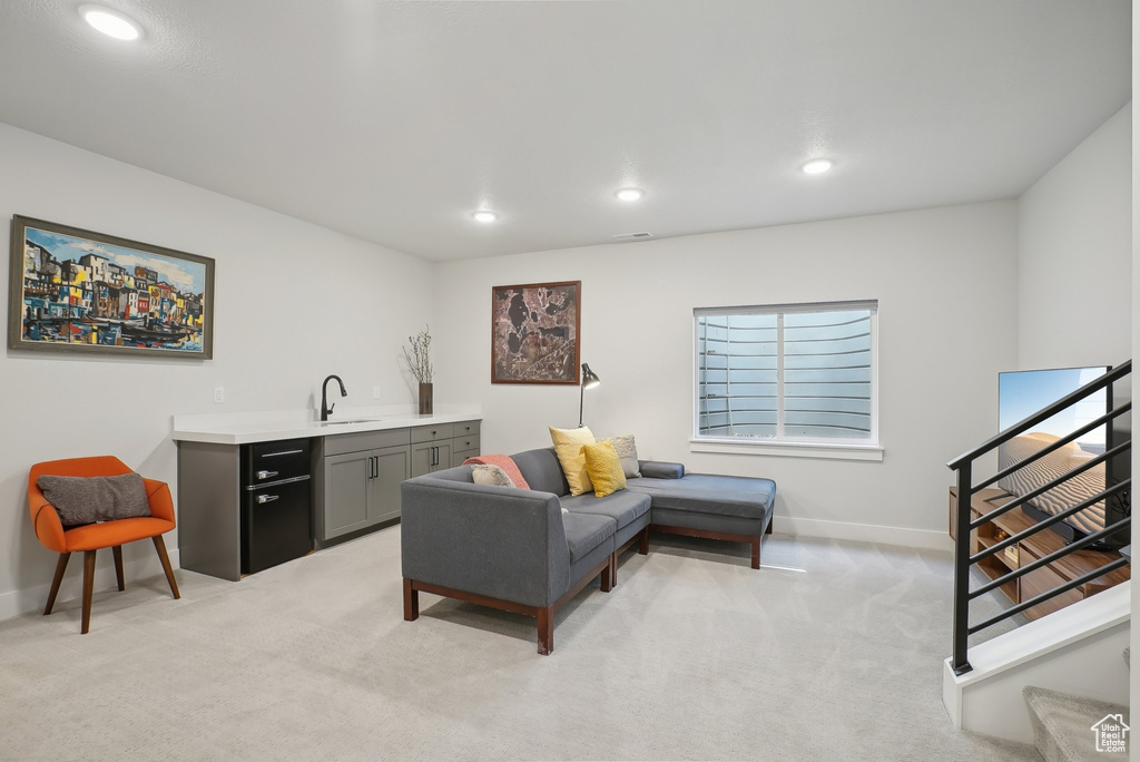 Living room featuring baseboards, light colored carpet, and recessed lighting