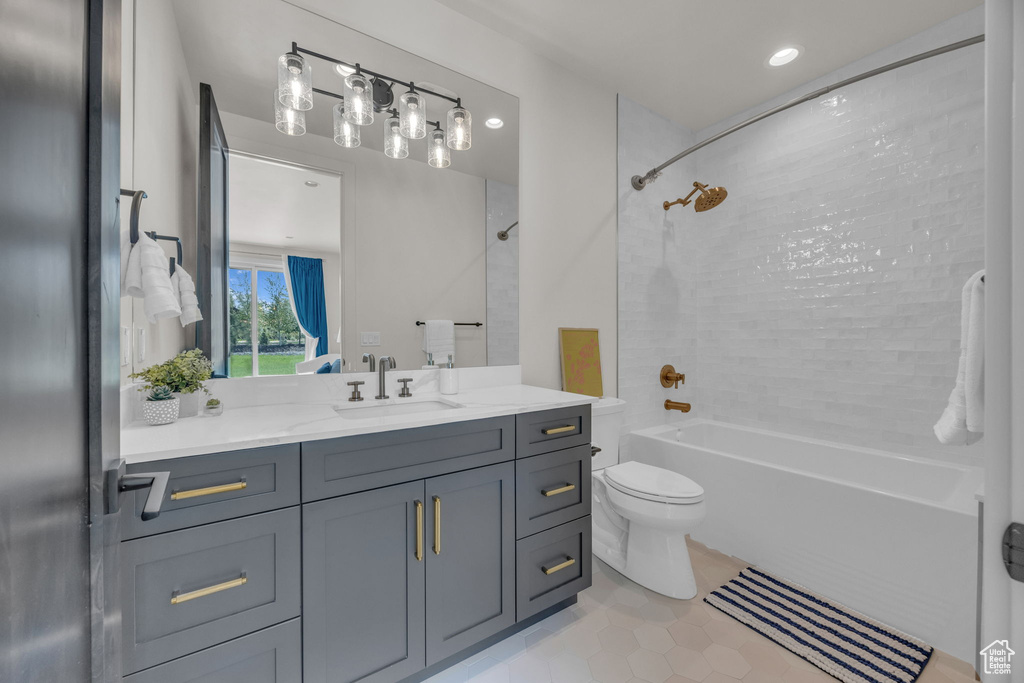 Full bath featuring shower / tub combination, vanity, toilet, and tile patterned flooring