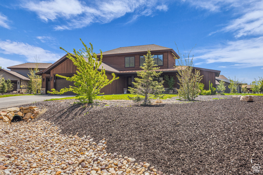 View of front of property featuring driveway and a garage