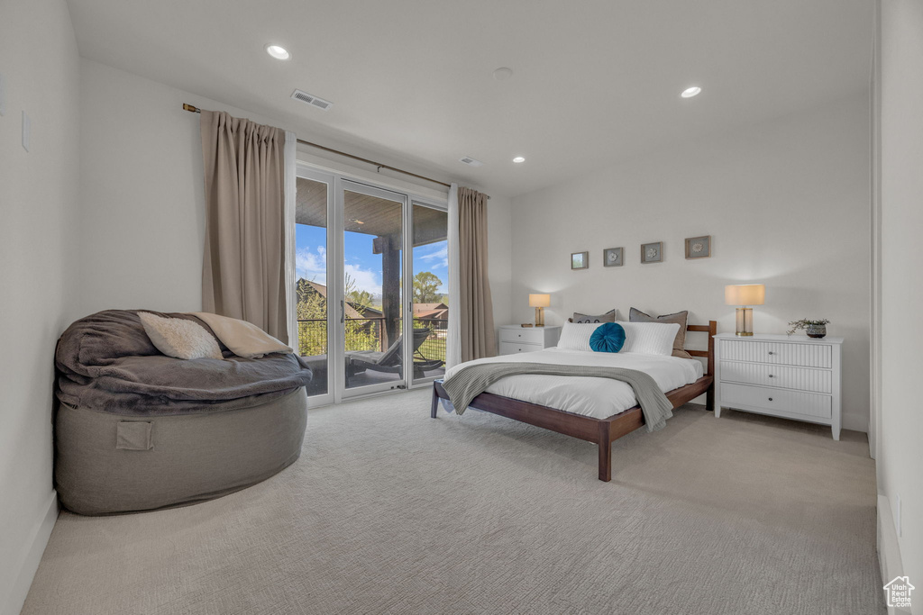 Bedroom with access to exterior, carpet flooring, and recessed lighting