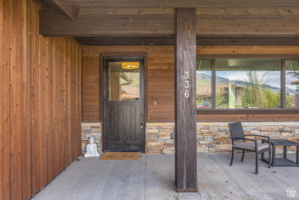 Entrance to property featuring stone siding