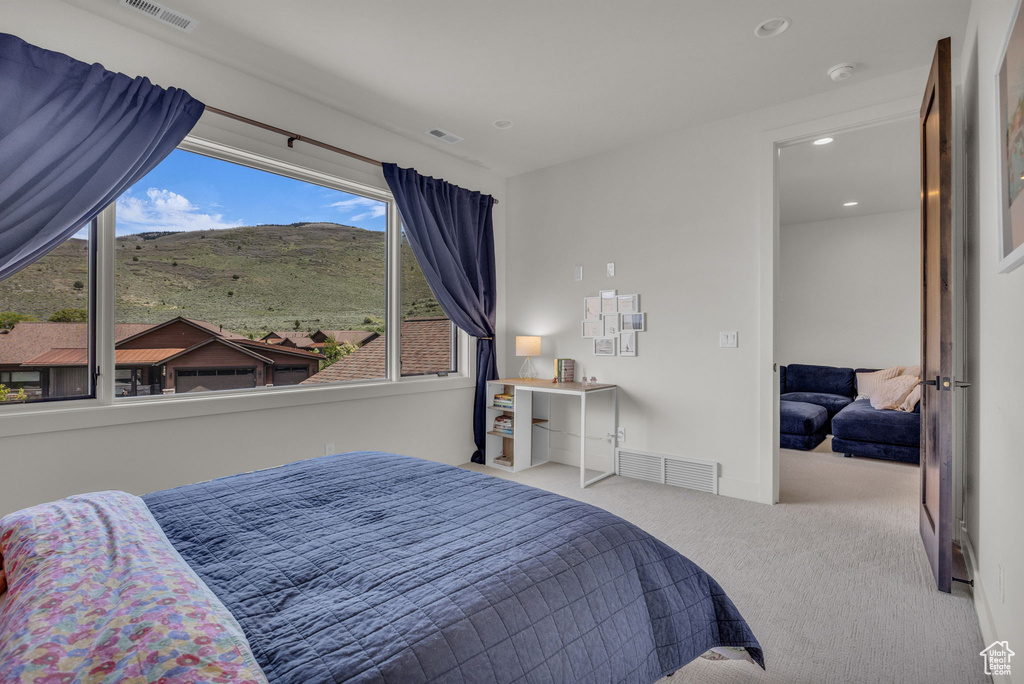 Carpeted bedroom featuring recessed lighting and a mountain view