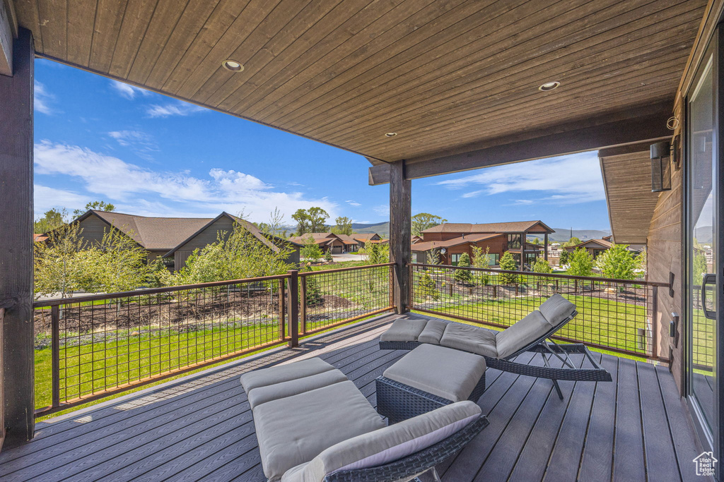 Deck featuring a residential view and a yard