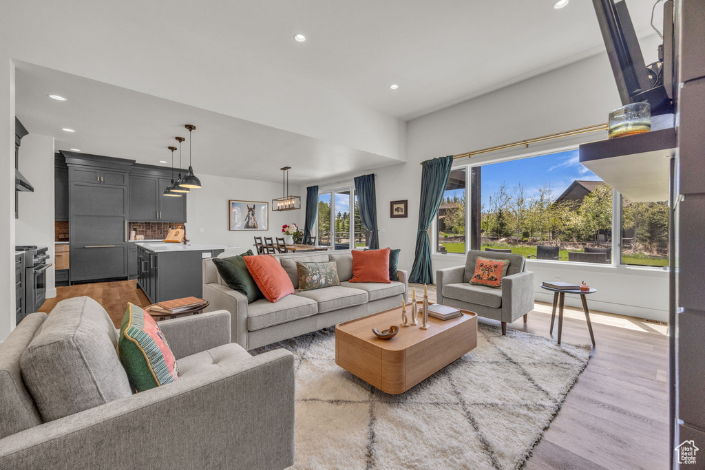 Living area featuring recessed lighting and light wood-style flooring