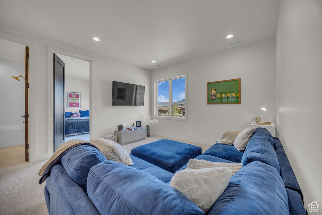 Carpeted living area featuring recessed lighting