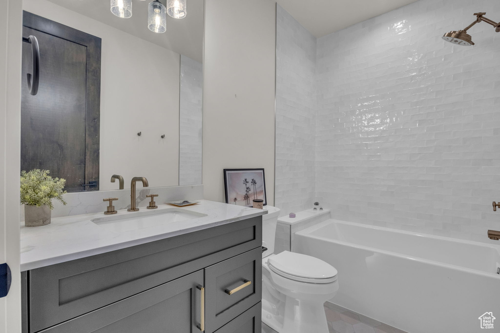 Bathroom with vanity, toilet, and shower / bathtub combination