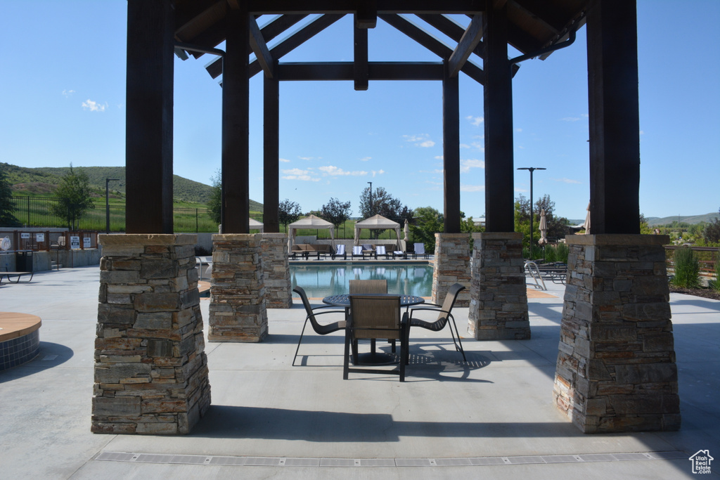 View of patio featuring a community pool and a gazebo