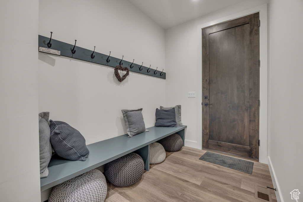 Mudroom featuring wood finished floors and baseboards