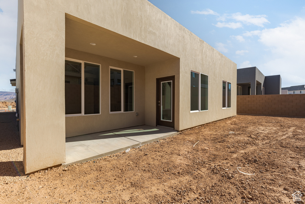 Back of house featuring stucco siding and a patio