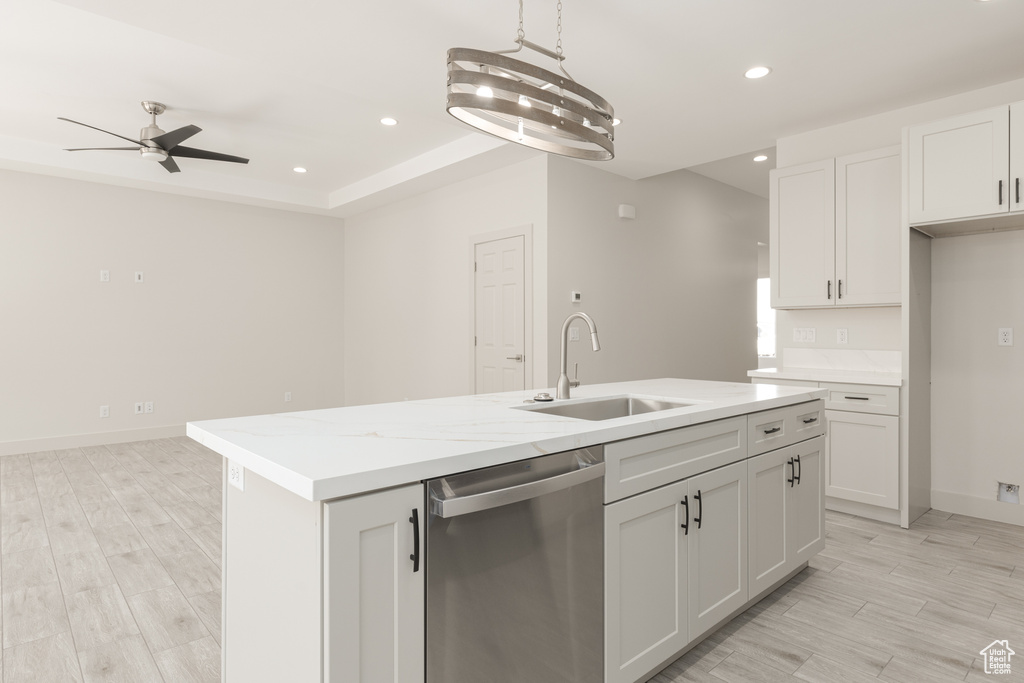 Kitchen with stainless steel dishwasher, a sink, ceiling fan, recessed lighting, and a center island with sink