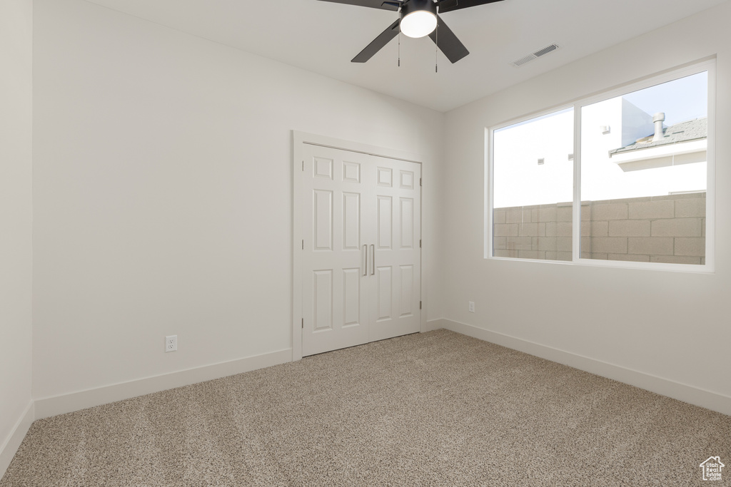 Unfurnished bedroom with carpet floors, baseboards, and a closet