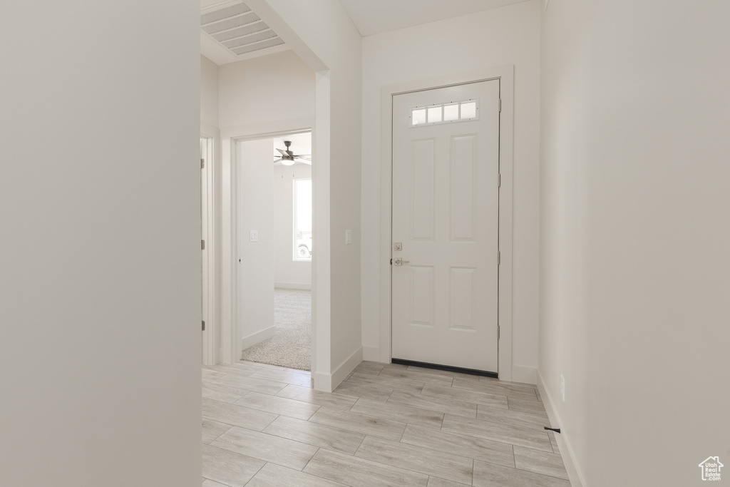 Entryway featuring baseboards and light wood-style floors