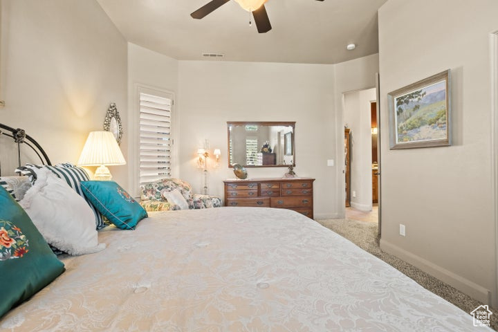 Bedroom featuring carpet, baseboards, and ceiling fan