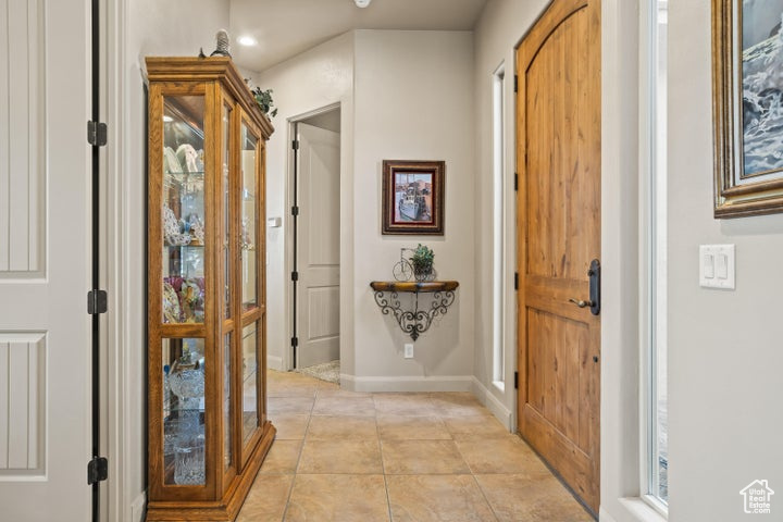 Entrance foyer featuring light tile patterned floors, baseboards, and recessed lighting