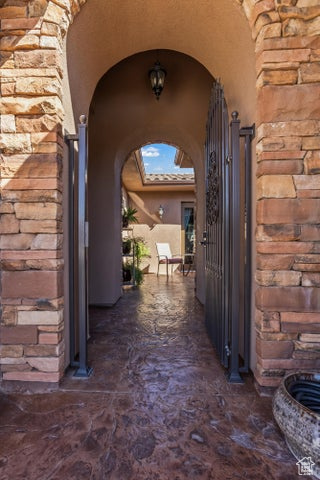 Entrance to property with stone siding and stucco siding