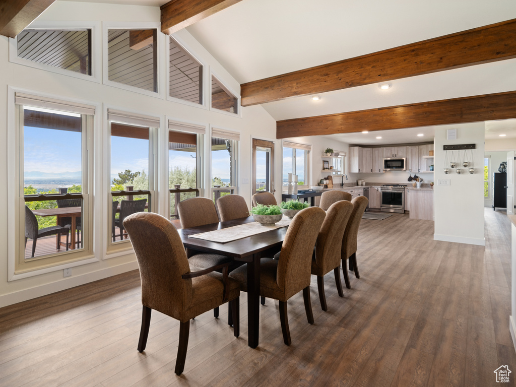 Dining area with plenty of natural light, light wood-style flooring, recessed lighting, and baseboards