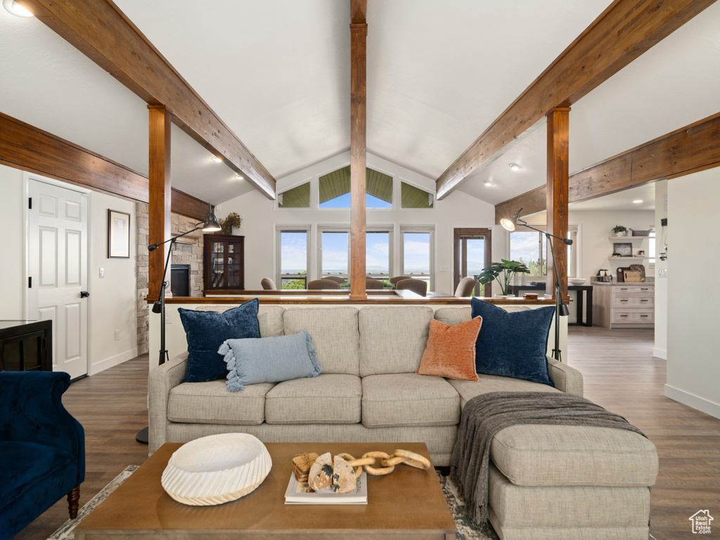 Living area featuring ornate columns, plenty of natural light, and wood finished floors