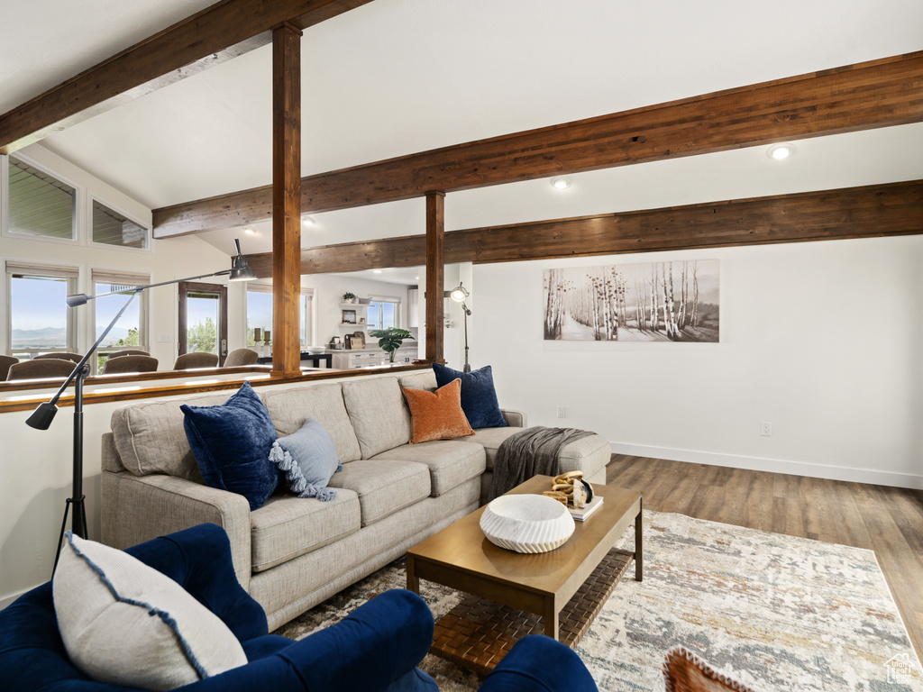 Living room featuring baseboards, recessed lighting, and wood finished floors