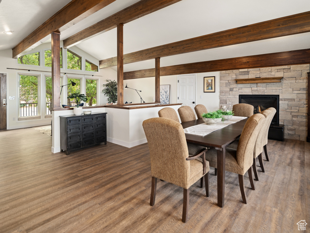 Dining area featuring wood finished floors, baseboards, and a fireplace