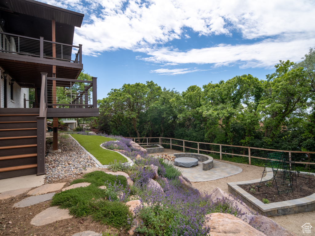 View of yard with a patio, stairs, an outdoor fire pit, a deck, and a balcony
