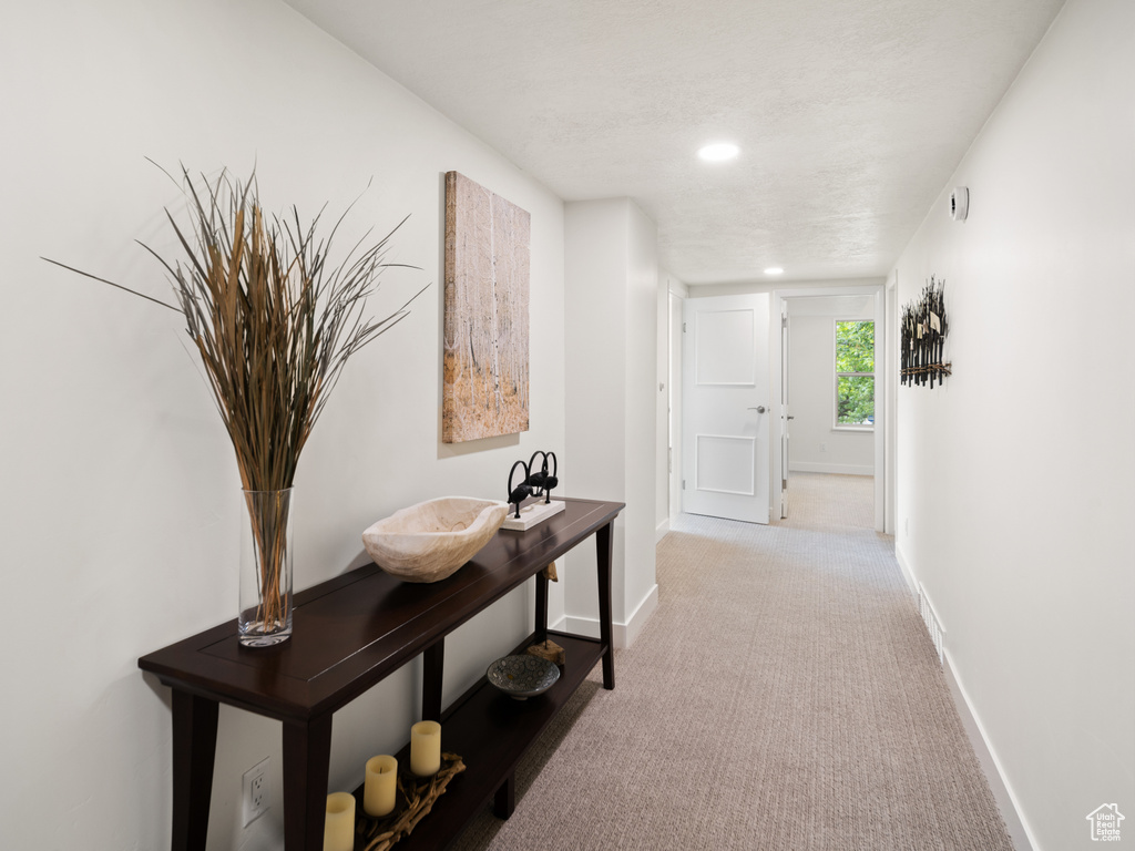 Corridor featuring baseboards, carpet floors, and recessed lighting