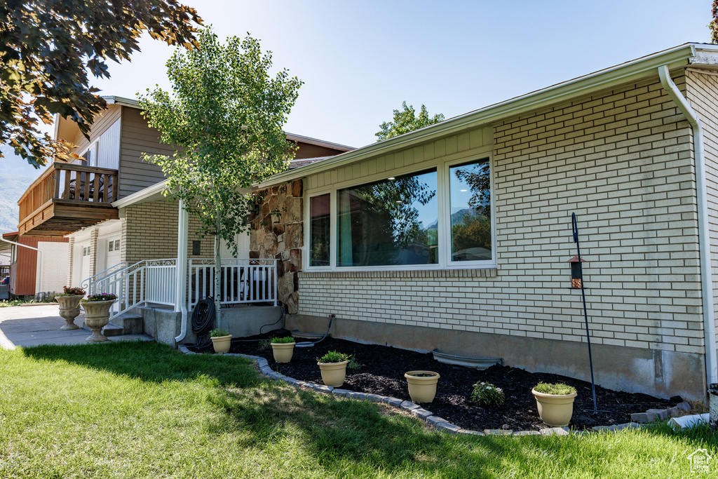 View of front facade with brick siding and a front lawn