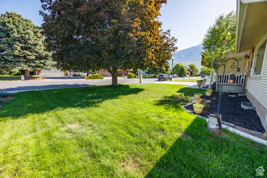 View of green lawn featuring a mountain view