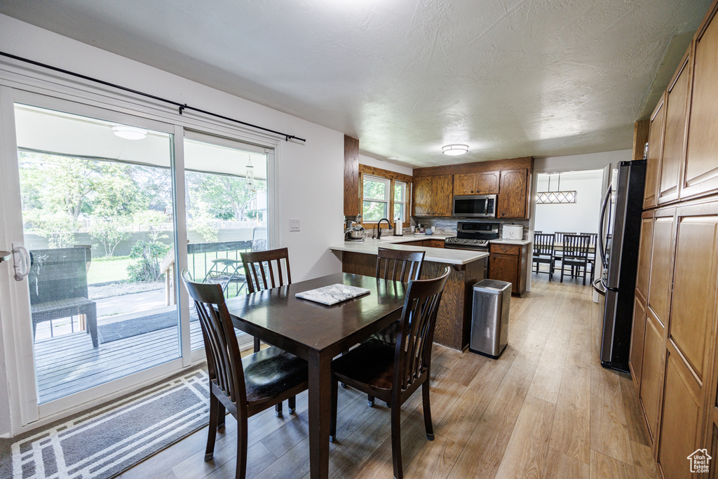 Dining space with light wood-style flooring