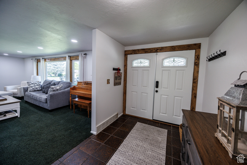 Entrance foyer featuring baseboards and recessed lighting