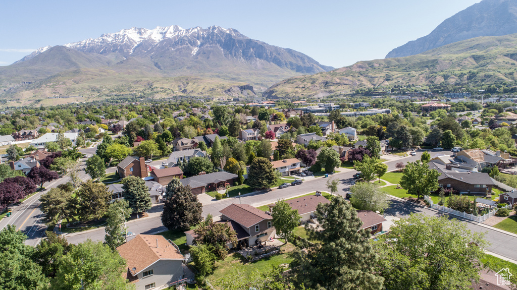 Aerial view of residential area featuring a mountainous background