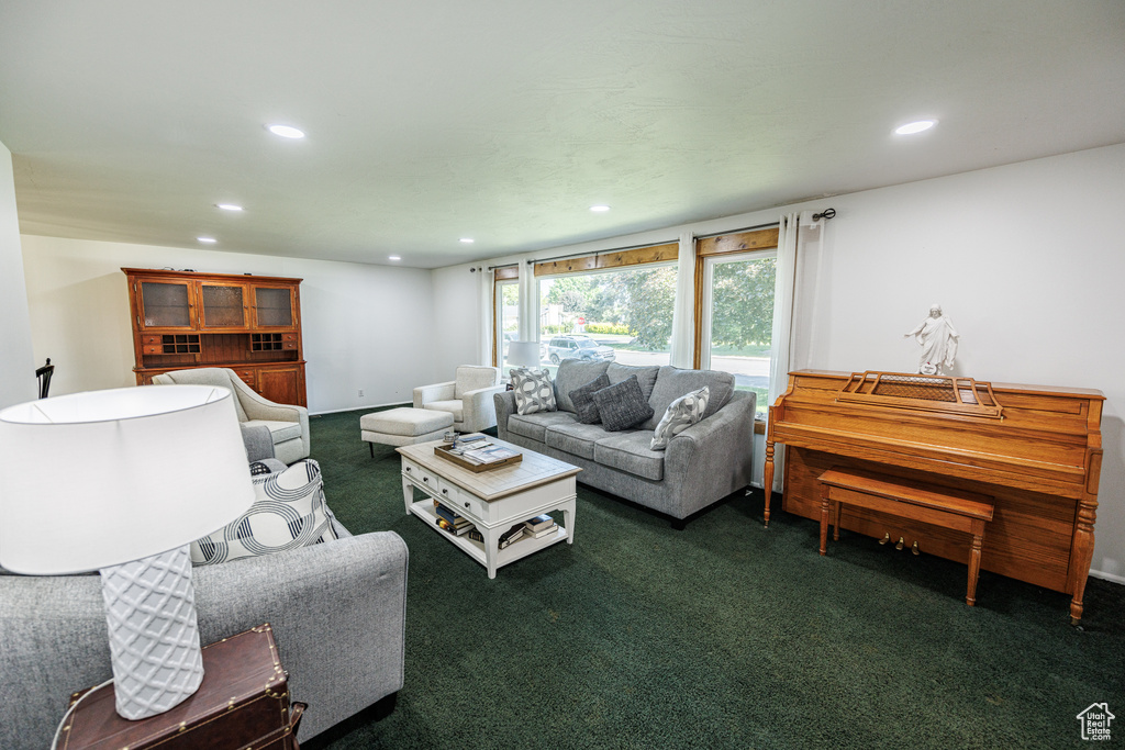 Living area featuring recessed lighting and dark colored carpet