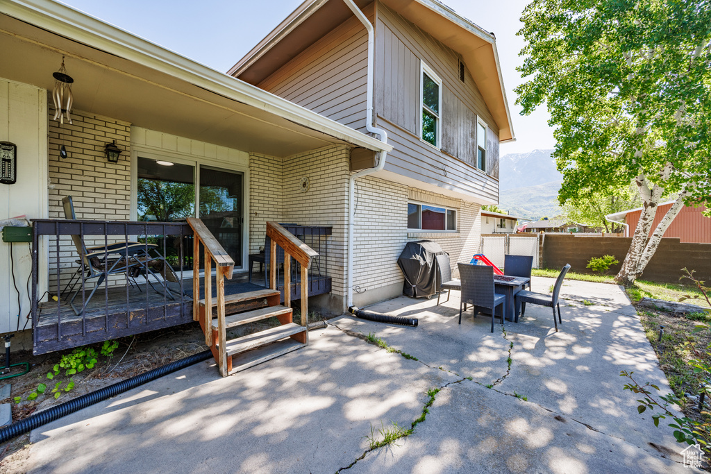 View of patio / terrace with grilling area and a deck with mountain view
