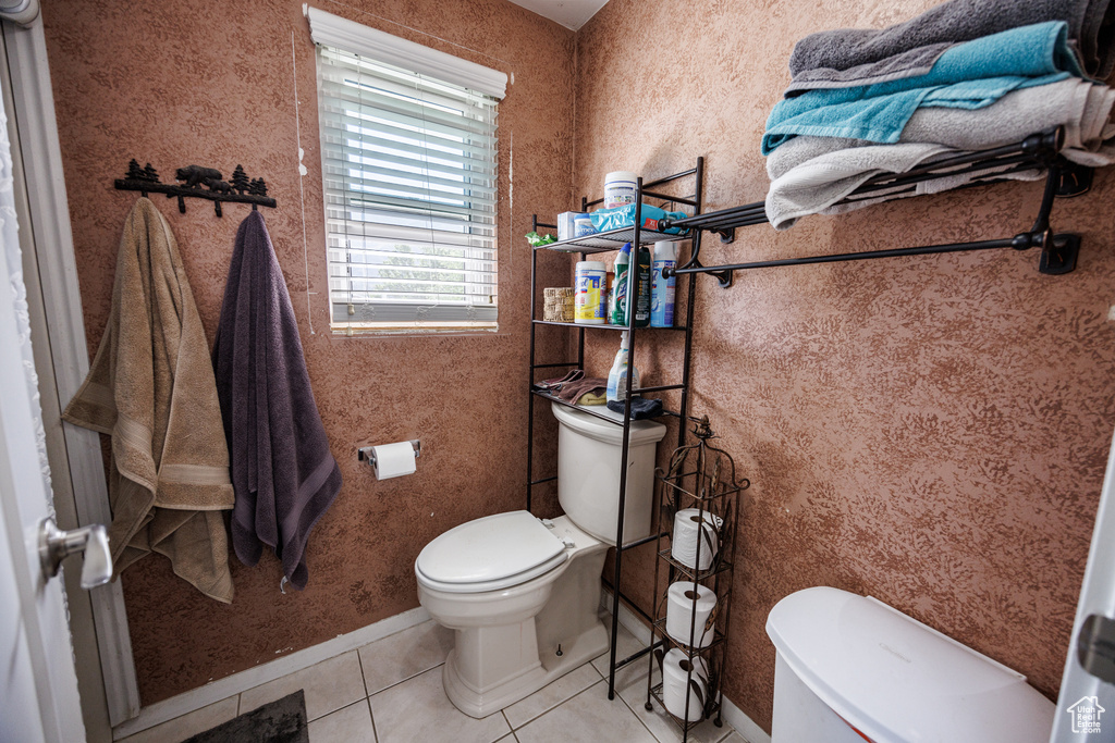 Bathroom with toilet and tile patterned floors