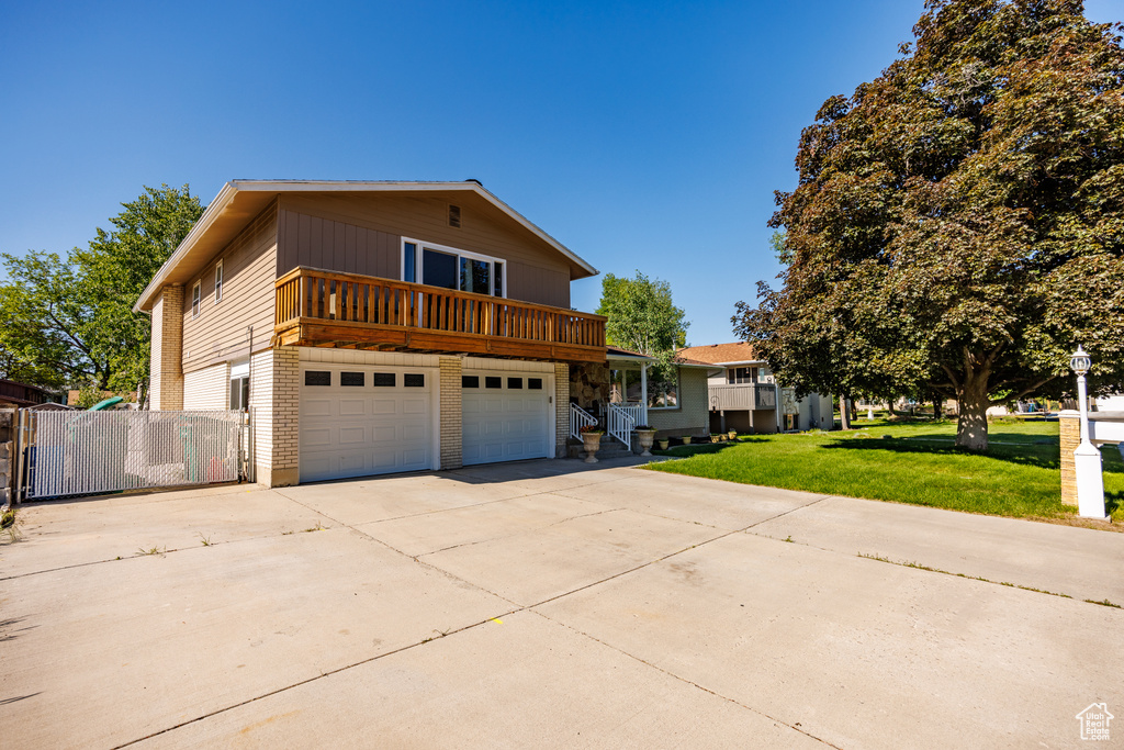 Traditional-style home featuring driveway, a garage, and brick siding