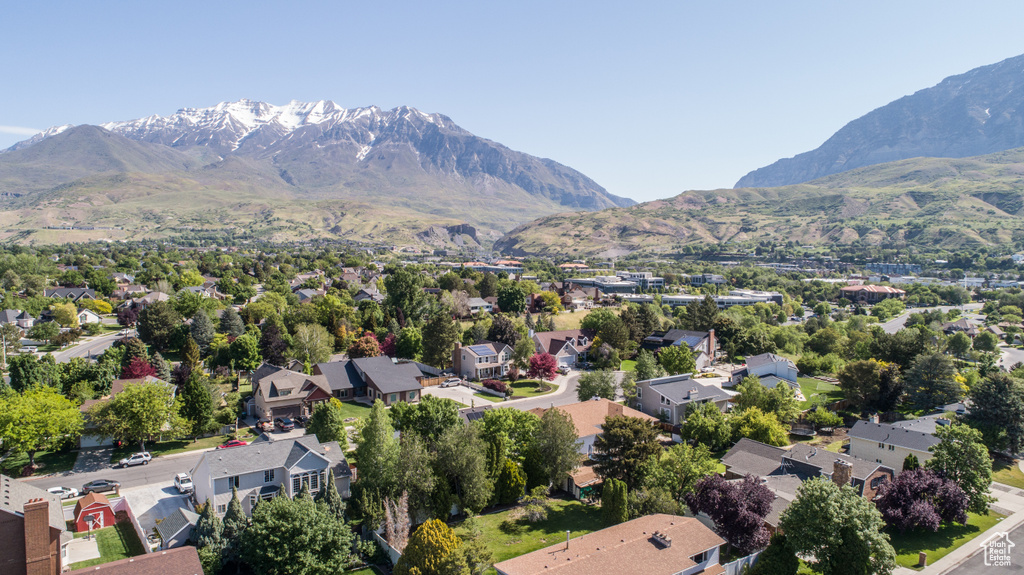 Aerial perspective of suburban area featuring a mountain backdrop