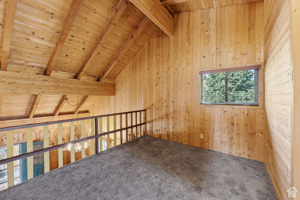 Bonus room with wood ceiling, wood walls, and carpet floors