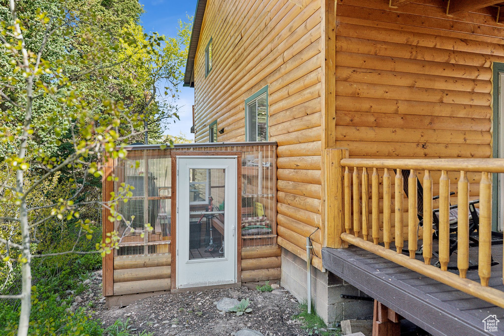 Property entrance with faux log siding
