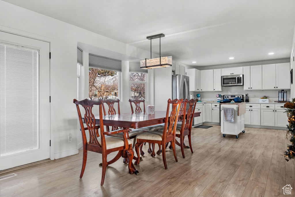 Dining area featuring light wood-style flooring, recessed lighting, and baseboards