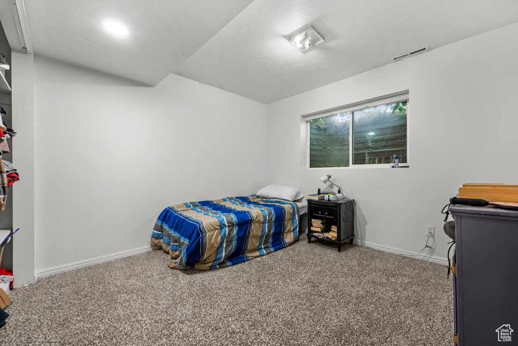 Bedroom with carpet flooring and baseboards