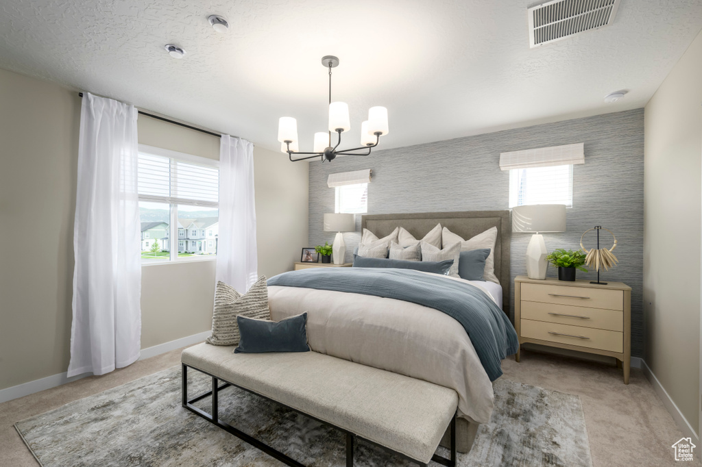 Bedroom featuring a chandelier, baseboards, light colored carpet, an accent wall, and wallpapered walls