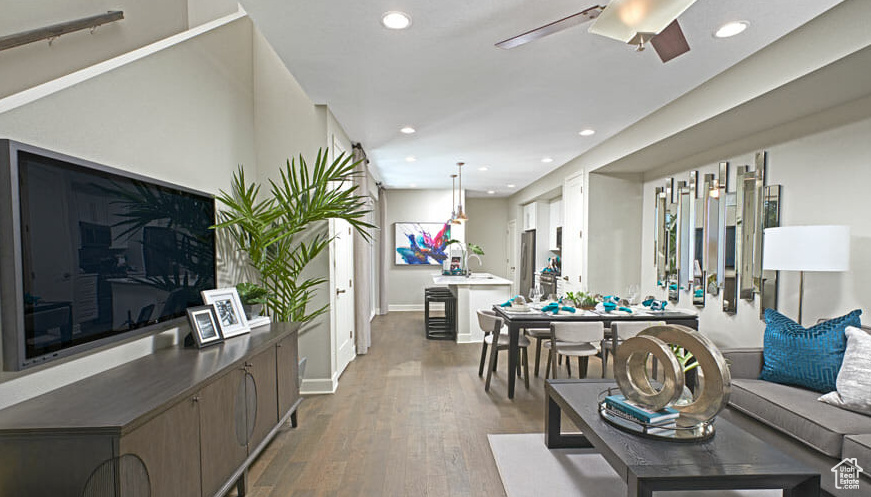 Living area featuring wood finished floors, ceiling fan, and recessed lighting